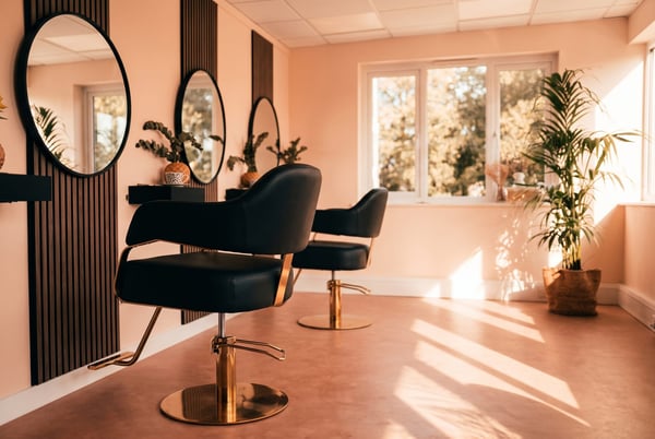 A styling chair and round mirror at NU Beauty's hair studio in Haverhill, ready for a colour appointment