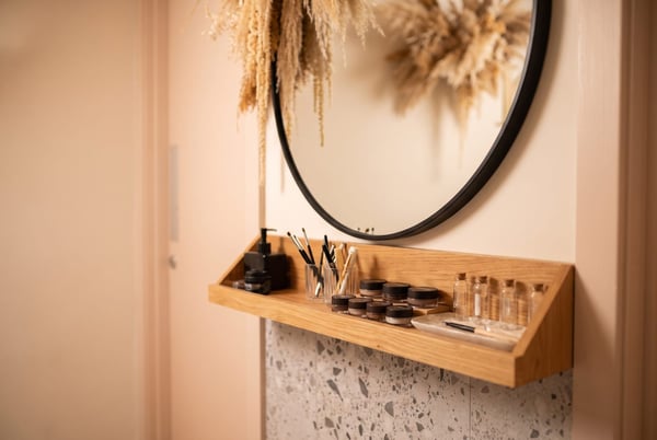 The calm brow treatment area at NU Beauty, with a round mirror, soft lighting and a tidy shelf of brow tools, ready for a shaping or tint appointment