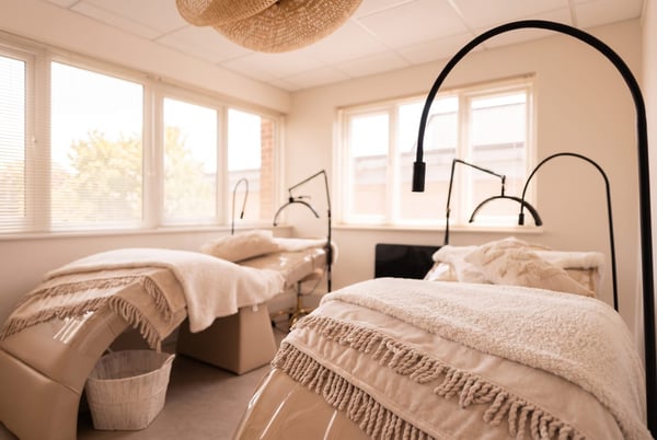 The calm brow and lash treatment room at NU Beauty in Haverhill, with a made bed and warm daylight, ready for an HD brows appointment