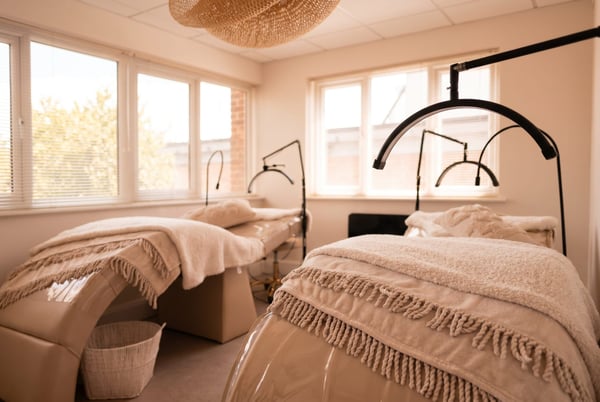 The brow and lash treatment room at NU Beauty in Haverhill, with cosy treatment beds and arched LED lamps