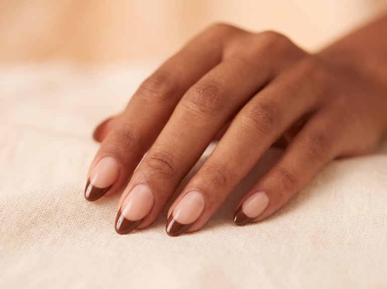 Autumn 2026 nail idea: Medium almond nails with chocolate-brown French tips over a sheer nude base